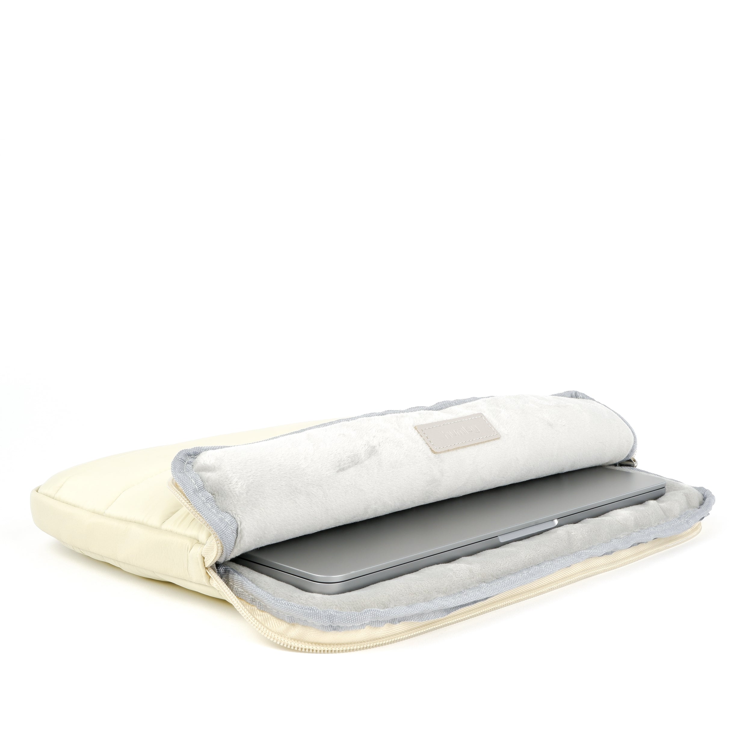 Beige Humley padded laptop sleeve open to reveal soft plush lining with MacBook inside