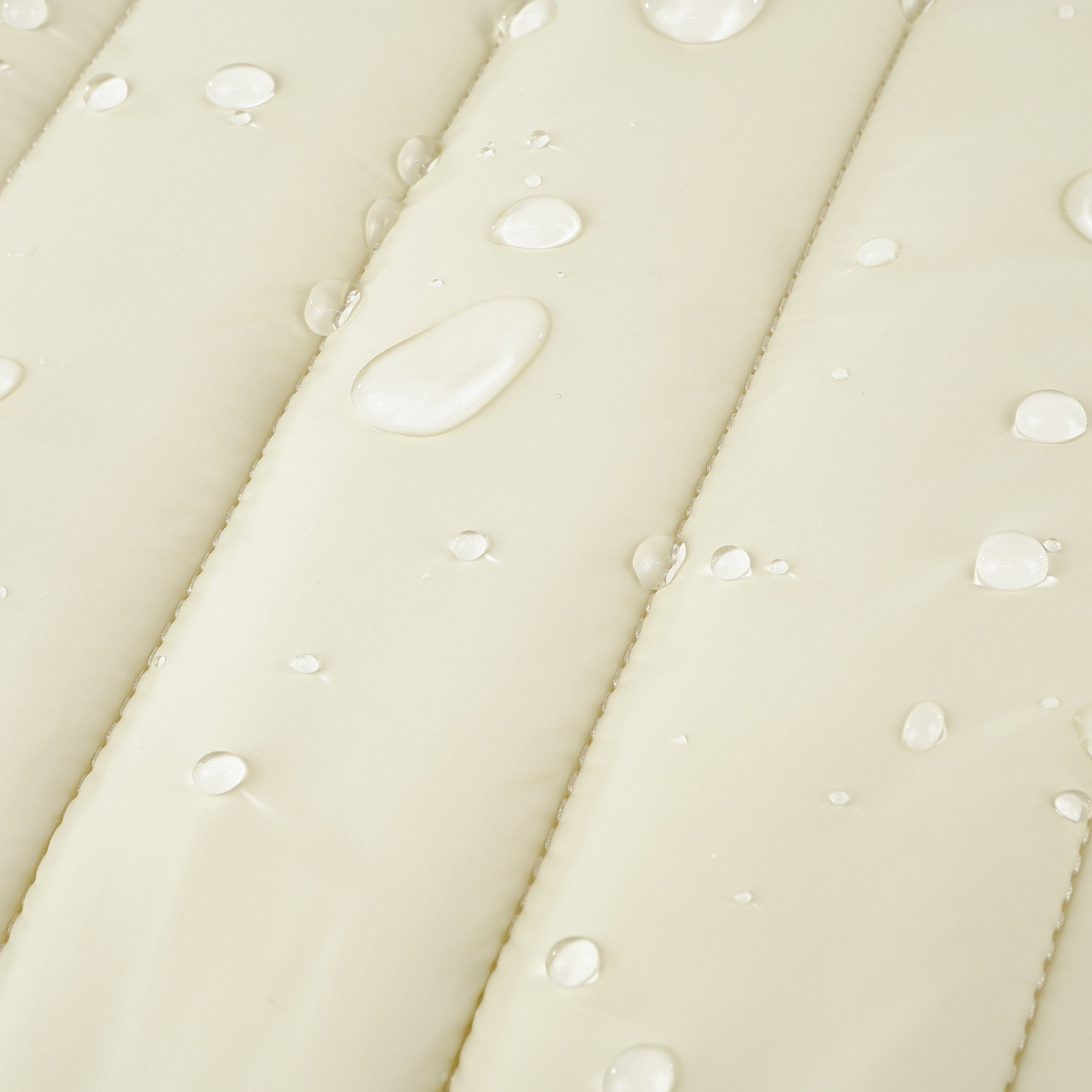 Close-up of beige Humley padded laptop sleeve with water droplets showing water-resistant material