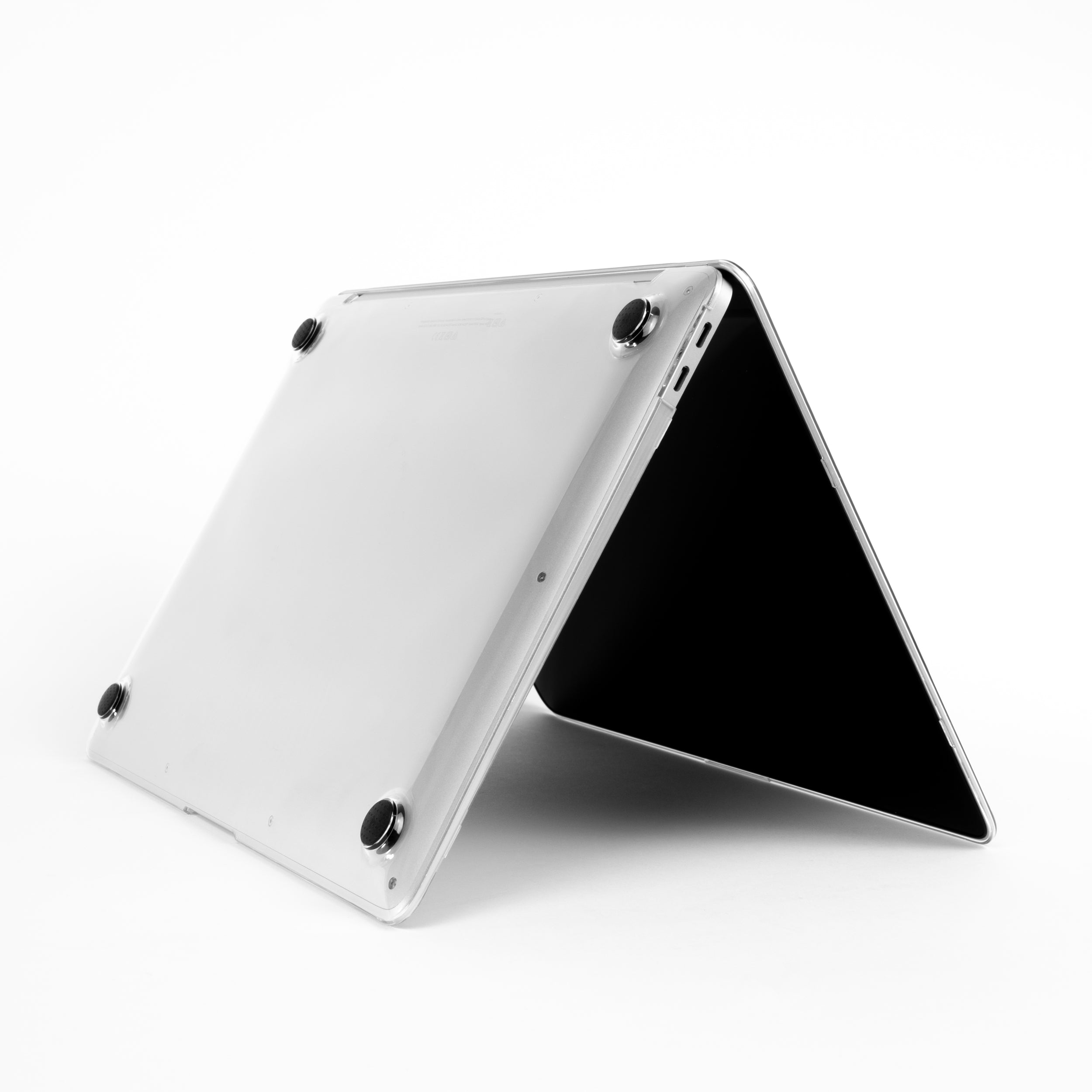 Bottom view of MacBook Air M1 in Humley clear hard case showing non-slip rubber feet and slim fit design